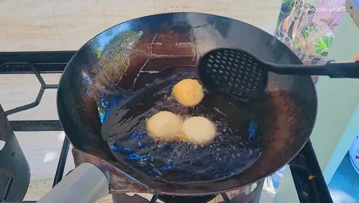Fry until golden brown and crispy, using a strainer to remove excess flour from the pan between batches.