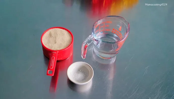 Prepare the sugar coating: Combine sugar, water, and salt in a pan. Heat over medium heat, stirring until the sugar melts and forms large bubbles.