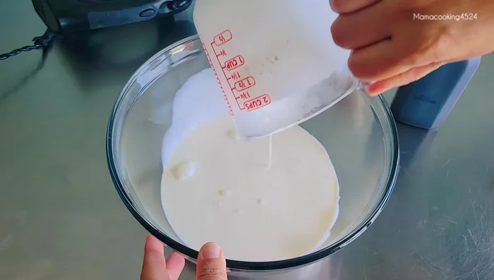 Whip cold cream with vanilla extract until stiff peaks form. Gradually add half the condensed milk at a time, mixing until combined.