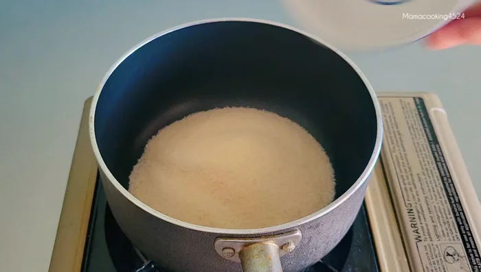 Make the caramel: Put sugar in a pot, turn on medium heat, and stir until dissolved.