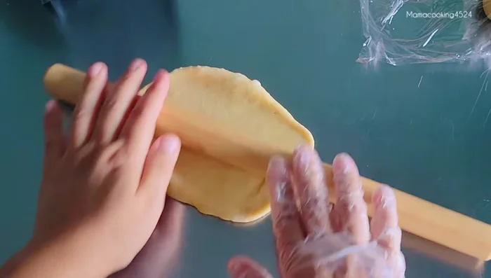 (Optional) For banana filling waffles: Roll out the dough wider, add banana slices, and close the dough to create a filled waffle. Cook as usual.