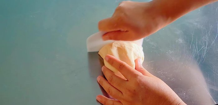 Divide the dough into 2 pieces, shape into balls, and let rest in oiled bowls for 1 hour.
