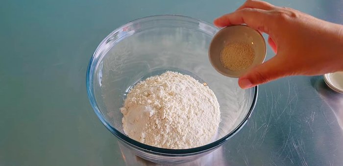 Make the pizza dough: Combine flour, salt, and yeast. Make a well in the center, add warm water and olive oil, and mix until a dough forms. Knead for 5 minutes until smooth.