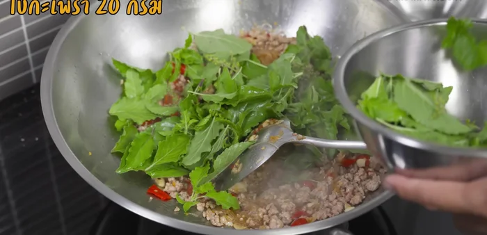 Add basil leaves and stir-fry briefly until fragrant.