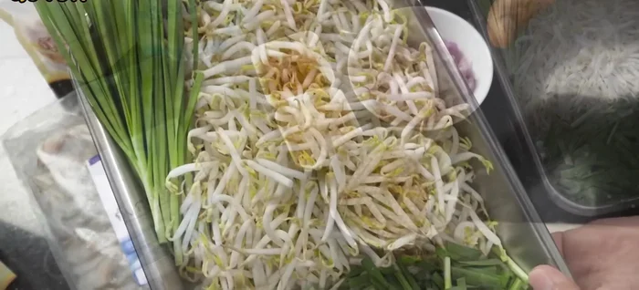 Prepare the Pad Thai ingredients: noodles, cubed yellow tofu, bean sprouts, chives, chopped peanuts, ground chili, dried shrimp, sun-dried shrimp, and fresh shrimp. Clean and devein the fresh shrimp.