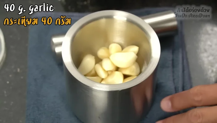 Pound the roasted dried chilies and garlic roughly in a mortar and pestle.