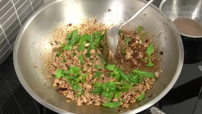 Add the basil leaves and stir-fry until wilted and fragrant.