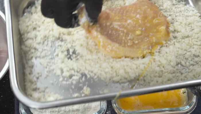 Fry the pork: Heat oil in a frying pan to 170-180°C. Fry the pork cutlets in batches, ensuring not to overcrowd the pan. Fry for approximately 4 minutes per side, or until golden brown and cooked through. Adjust frying time according to pork thickness.