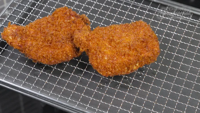 Rest and serve: Remove the fried pork from the pan and let it rest for 2-3 minutes to allow the juices to settle. Serve hot with shredded cabbage, tonkatsu sauce, soy sauce, and black pepper.