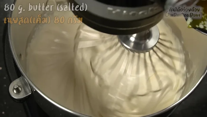Gradually add the warm melted butter while mixing at low speed.