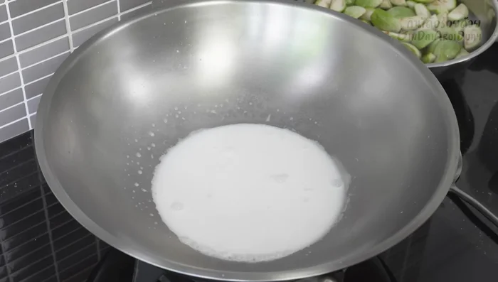 Heat the pan and add coconut milk. Stir-fry over medium heat until the coconut milk separates and oil starts to appear (165.239).