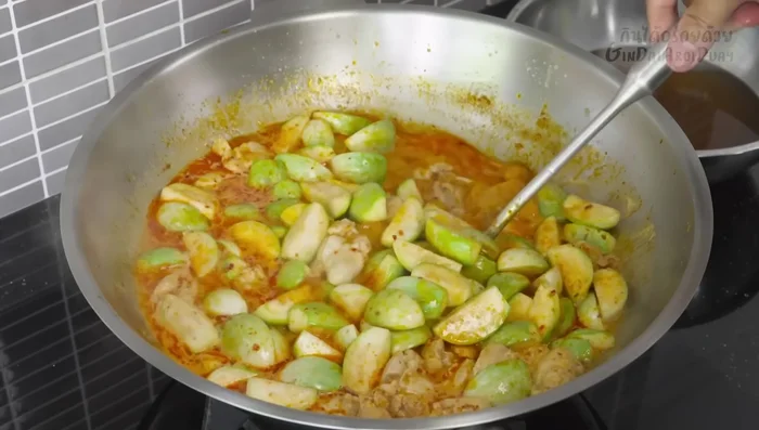Stir well, ensuring the eggplant is evenly heated (606.079).