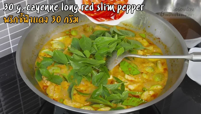 Add basil leaves and red chilies for garnish (700.399).