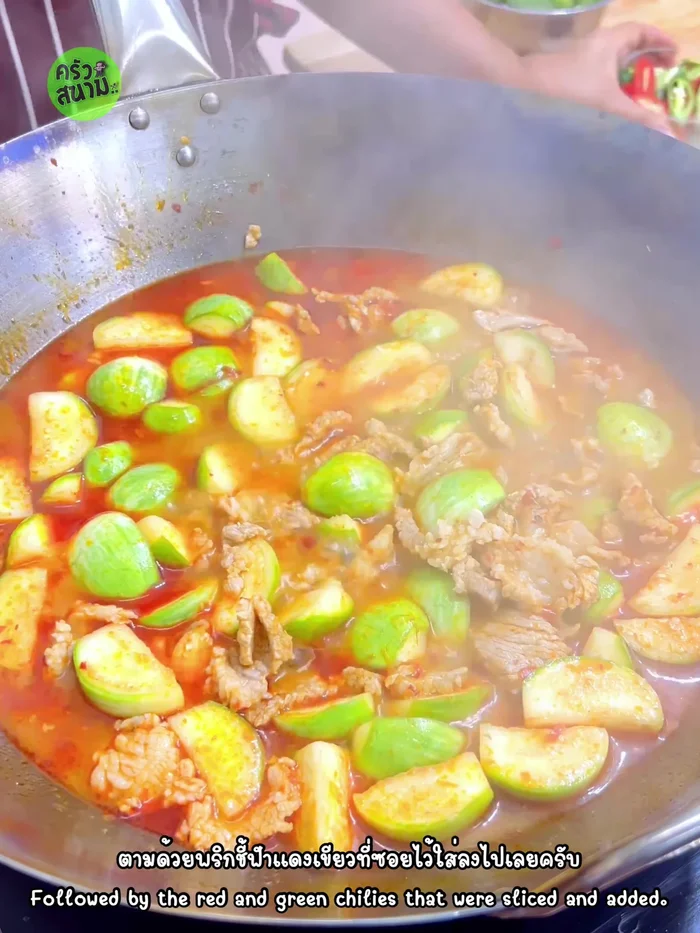 Add chili peppers and basil leaves, stir and simmer until fragrant.