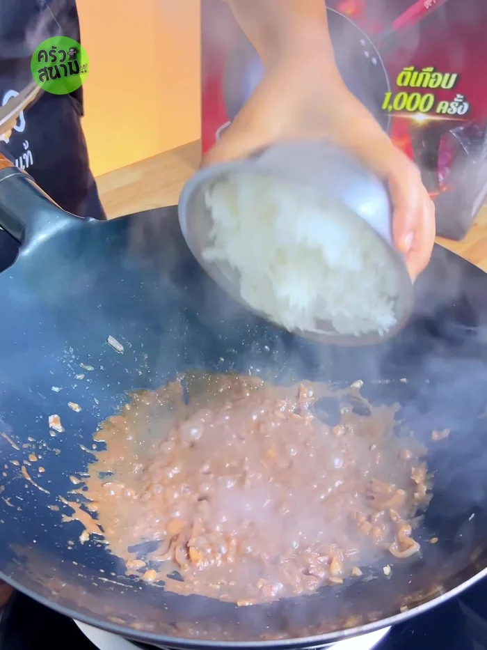 Add cooked rice, sugar, fish sauce, oyster sauce, and ground Thai basil. Stir and mix well.