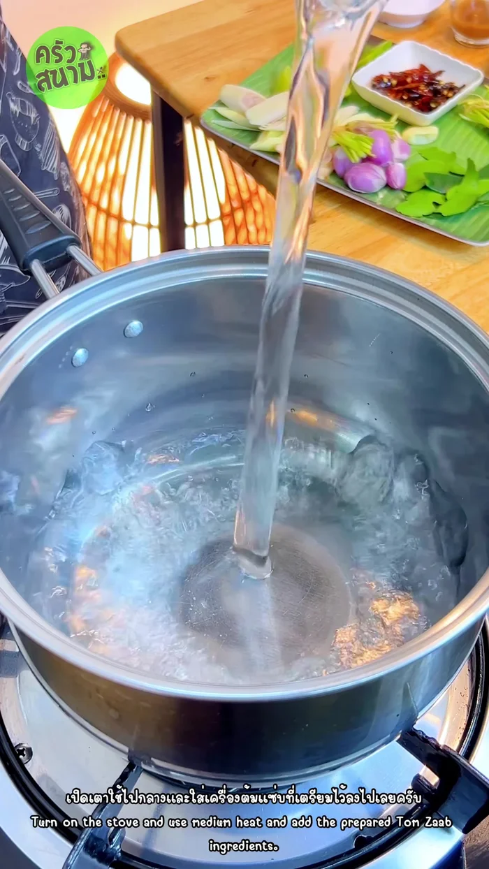 In a pot, combine 700ml of water and the prepared herb mixture. Bring to a boil over medium heat.