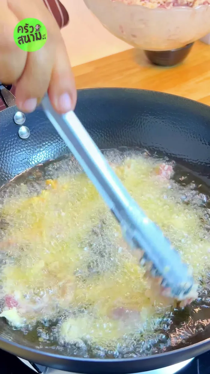 Fry the pork in two rounds. First round: Fry over medium heat until lightly yellow. Set aside to cool.