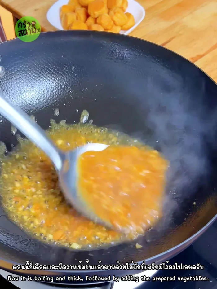 Add the chopped vegetables (shallots, spring onions, chili peppers) and stir-fry until wilted.