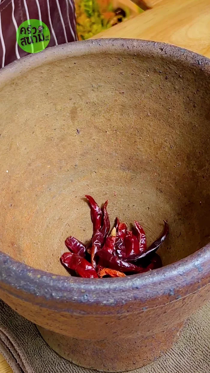 Pound the pork with dried chilies, fresh chilies, coconut sugar, and diluted tamarind juice until well blended. Adjust spiciness to your liking.