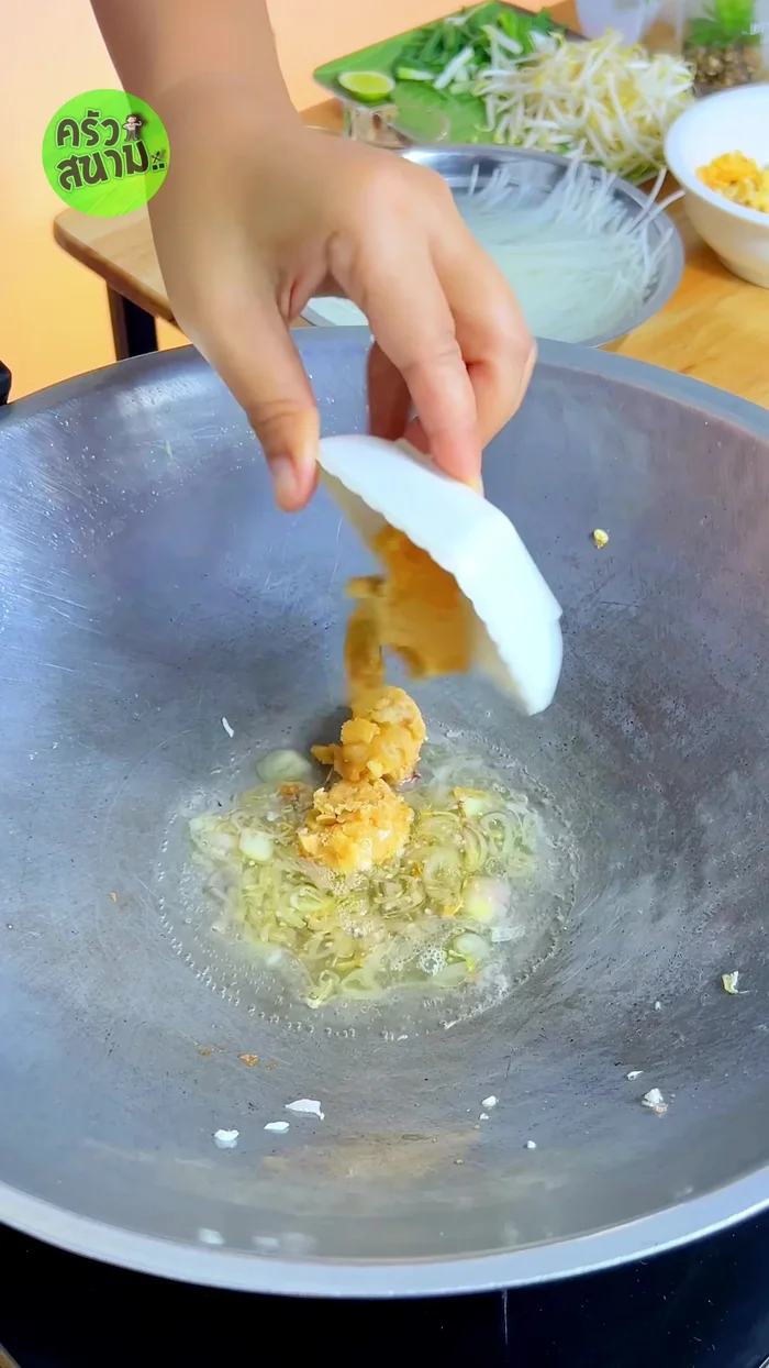 Add 5 tablespoons of water, 2 tablespoons of coconut sugar, 1 tablespoon of tamarind juice, 2 tablespoons of fish sauce, and 1/2 tablespoon of sweet soy sauce to the pan. Simmer until the coconut sugar dissolves.