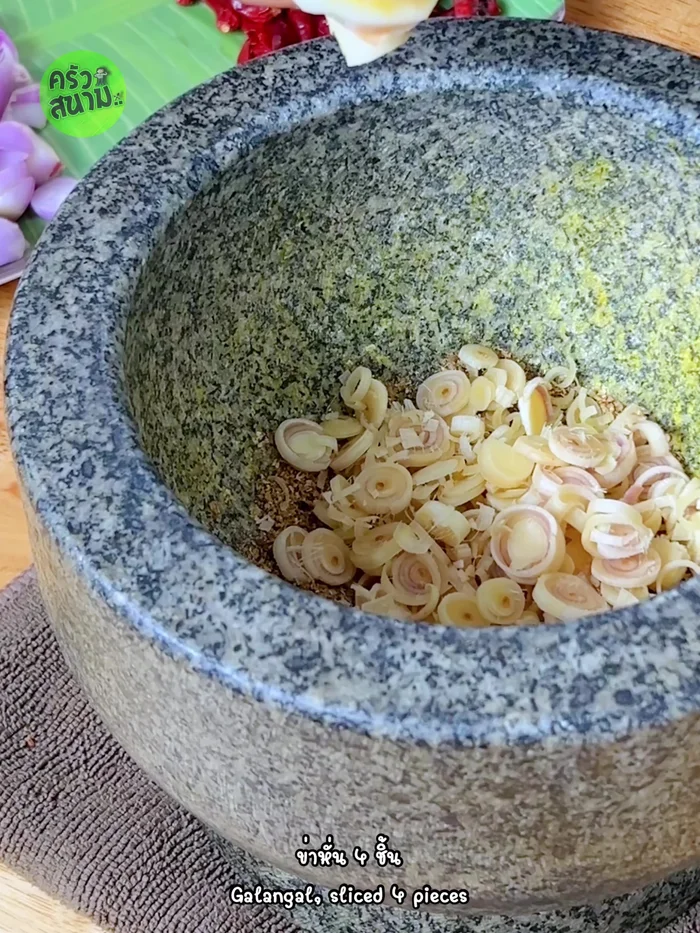Add sliced lemongrass, and coriander roots; pound until well blended.