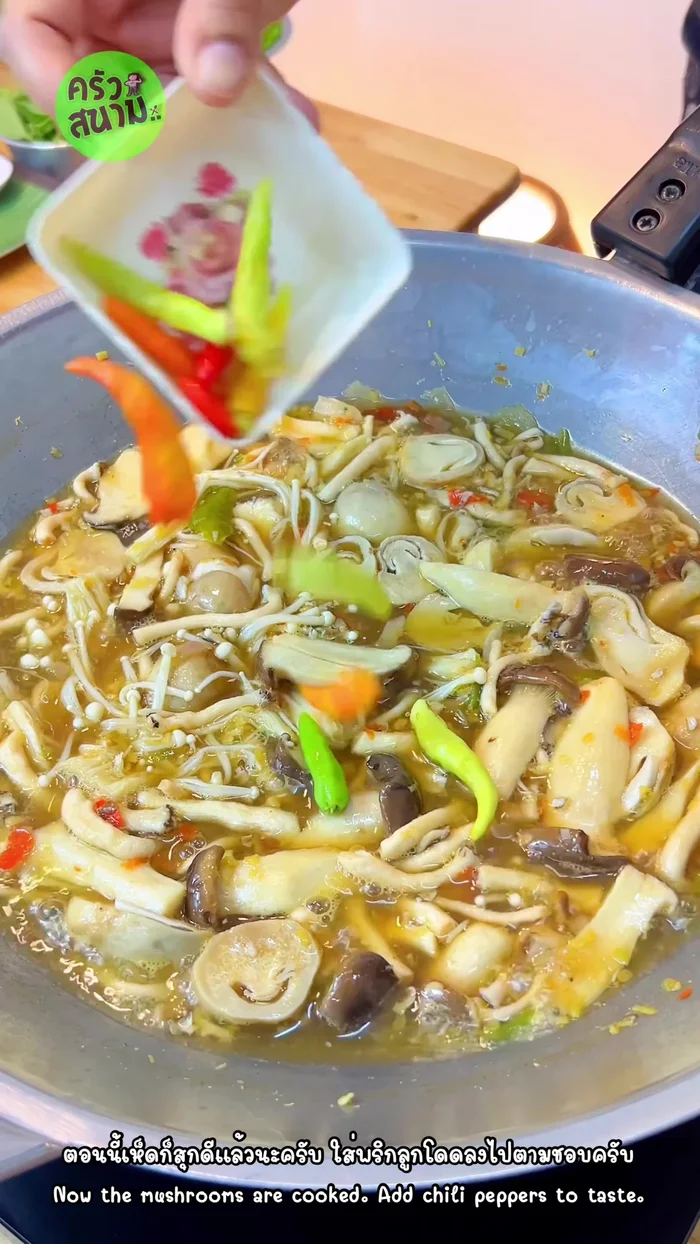 Add Cha-om and garnish: Add chili peppers and cha-om leaves to taste.