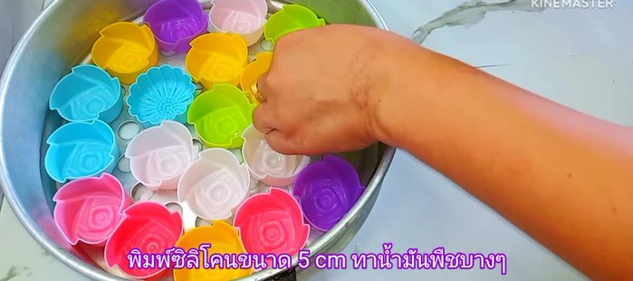 Oil 5cm silicone molds and dust with flour. Place a filling ball in each mold. Add dough to fill the mold, leaving space for expansion. Gently press the dough down.