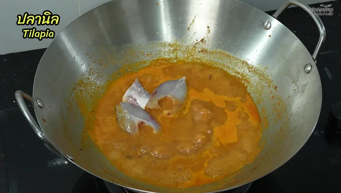 Add the tilapia pieces, ensuring they don't overlap. Cook until one side is done.