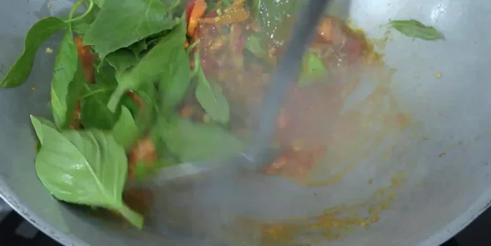Add basil leaves and stir-fry until wilted.