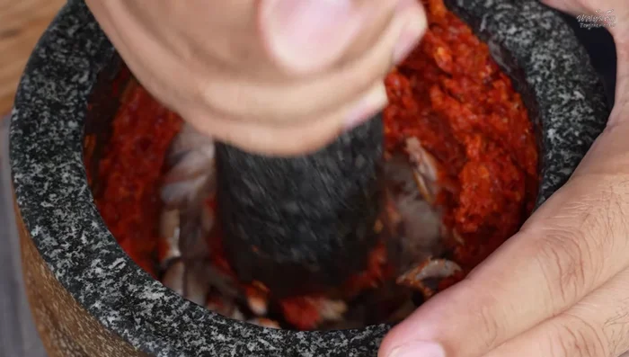 Add steamed tuna (or substitute with boiled fish) and pound with the curry paste.