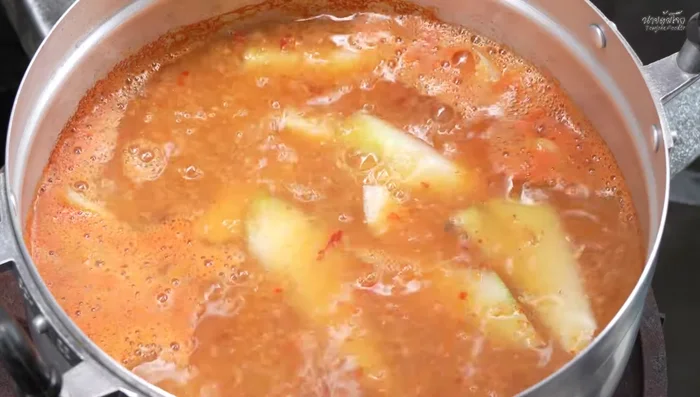 Add the sliced papaya and simmer until slightly softened but not mushy.