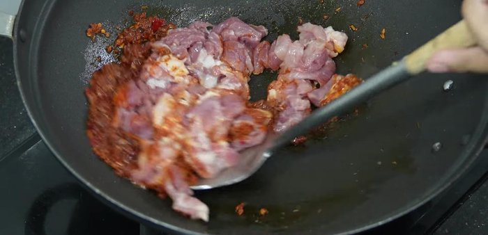 Add the pork and stir-fry over high heat until partially cooked. Sprinkle with torn kaffir lime leaves.