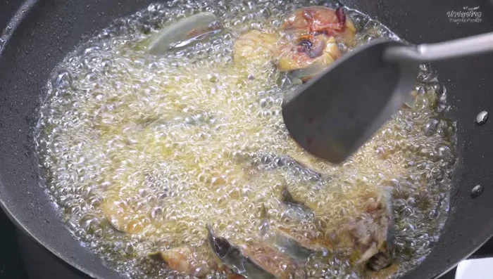 When the oil is hot, add the fish and fry until crispy on the outside and soft on the inside. Spread the fish out to ensure even cooking.