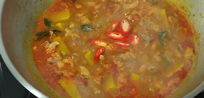 Taste and adjust seasoning. Add chili peppers and basil leaves to garnish.