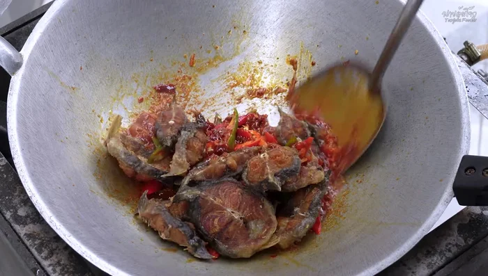 Add the fried catfish and stir-fry until the sauce coats the fish.