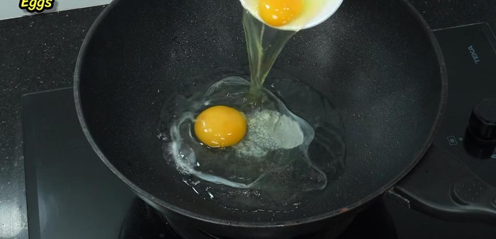 In the same pan, add the eggs and stir-fry until they are set and broken apart.