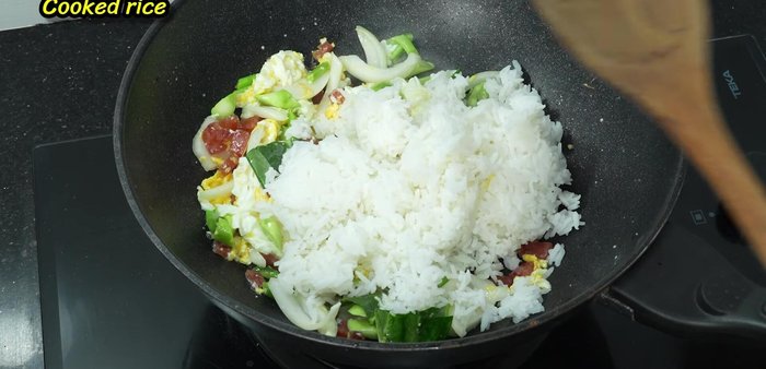 Add the cooked rice and stir-fry until it’s broken up and heated through. Use high heat towards the end.