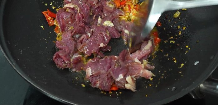 Add the marinated beef and stir-fry until almost cooked.