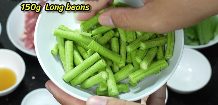Prepare the yardlong beans by cutting them into pieces and boiling until cooked.