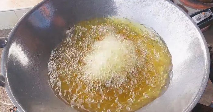 Carefully add the pork balls to the hot oil, frying them one at a time and stirring gently to prevent sticking. Maintain medium heat to ensure the inside cooks through.