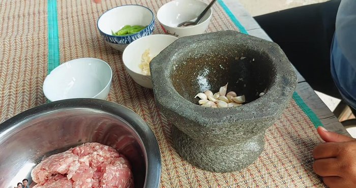 Pound 1 clove of Thai garlic, 5 stalks of coriander root, and ½ teaspoon of peppercorns for the marinade.