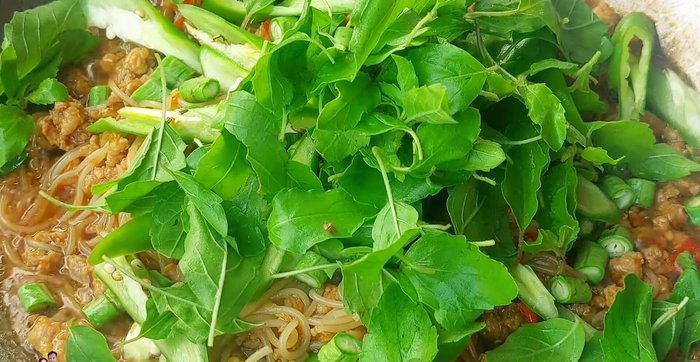 Finish with basil leaves and stir-fry until wilted.