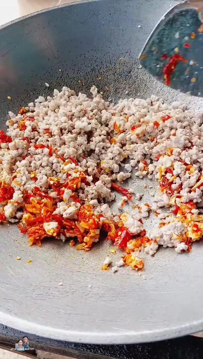 Add pounded chilies and garlic. Mix well and stir-fry with the minced pork.