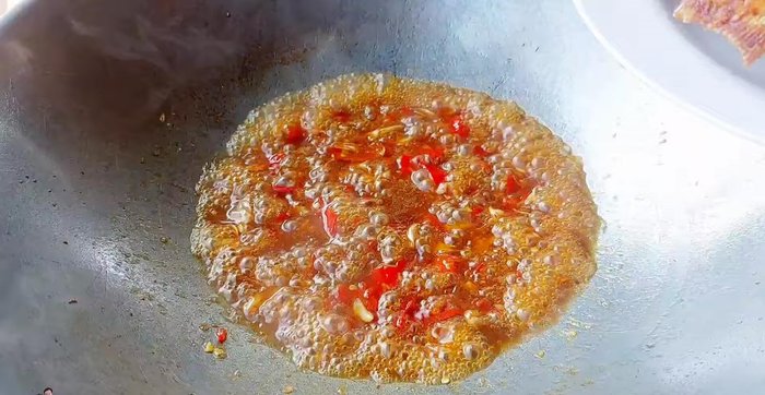 Add the fried tilapia to the sauce and stir-fry.