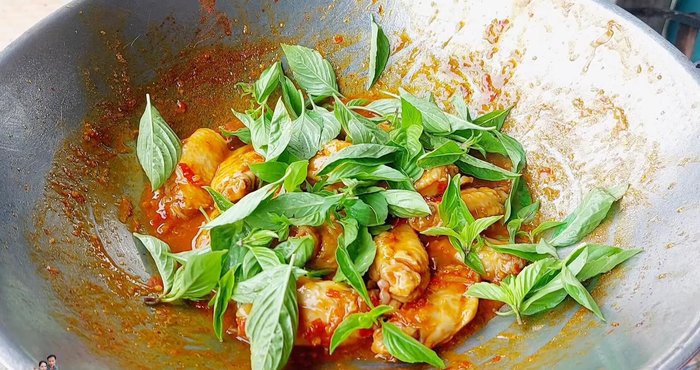Add chopped fresh basil leaves and chili for flavor and color.