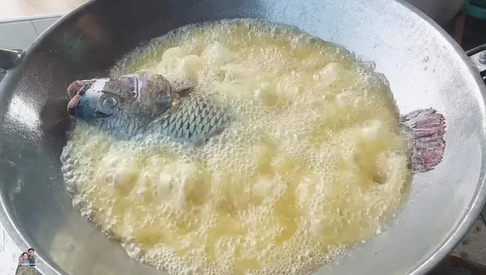 Add tilapia to the hot oil. The flour in the oil helps prevent sticking and splattering.