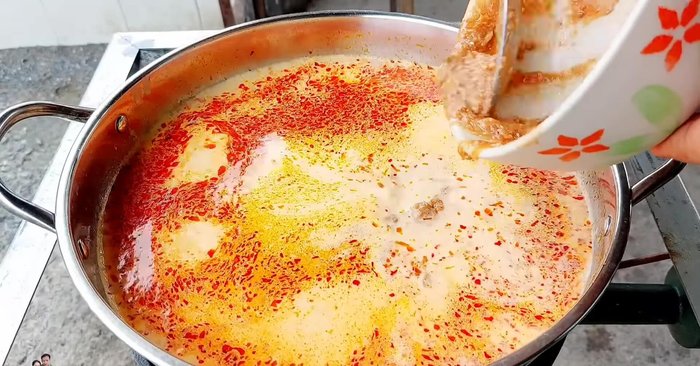 Add the ground canned fish to the pot.