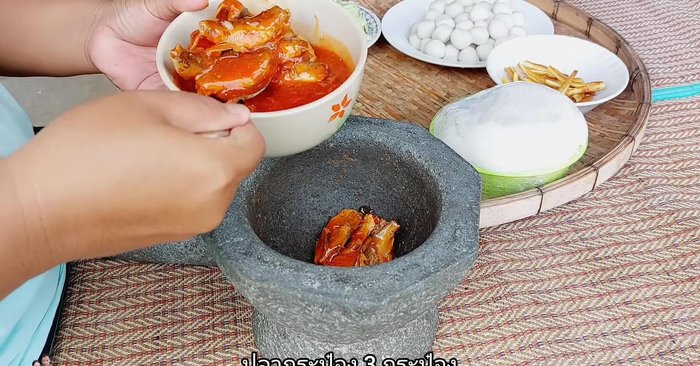 Grind canned fish finely in a mortar.
