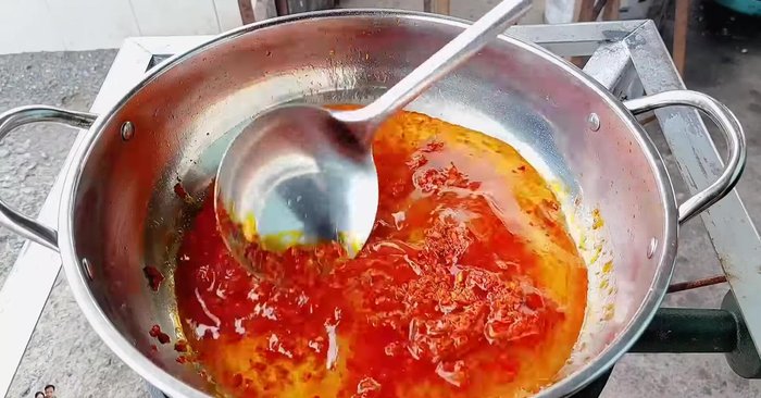 Add a little water and continue to stir-fry until the curry paste and coconut milk are well blended.