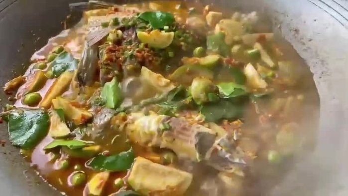 Prepare the ingredients. Clean and cut the fish into pieces. Finely chop the chilies, shallots, garlic, turmeric, lemongrass, and galangal.